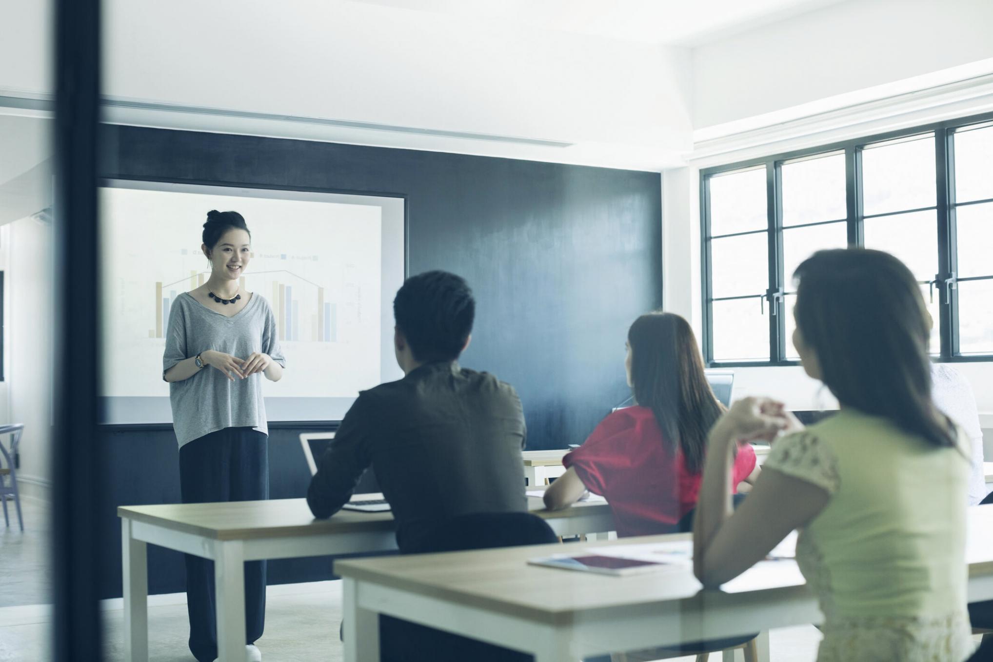 Student examining tree seedling growth patterns during field practicum session